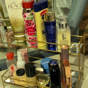 Elegant double-layer gold organizer with mirror - perfect for storing makeup, jewelry, and skincare while adding a luxurious touch to your vanity.