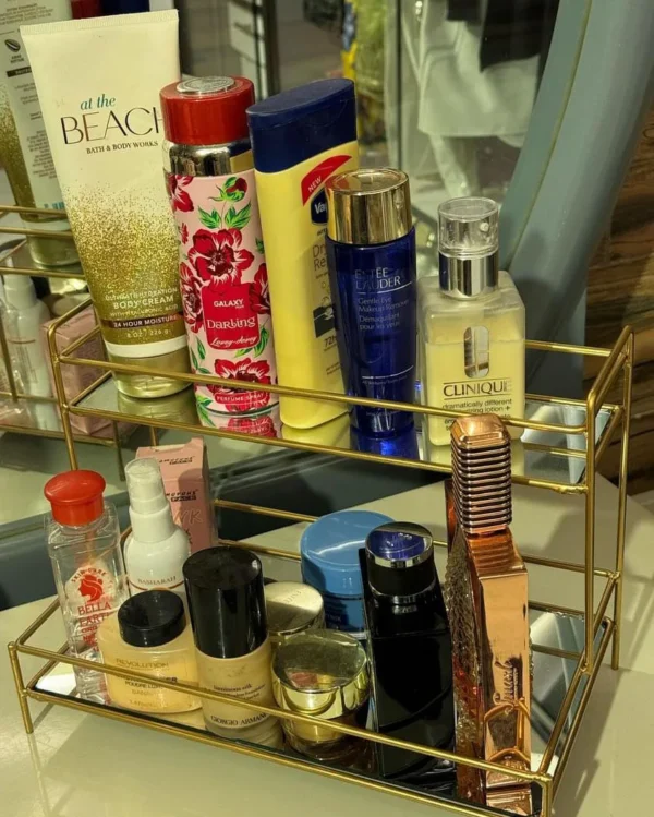Elegant double-layer gold organizer with mirror - perfect for storing makeup, jewelry, and skincare while adding a luxurious touch to your vanity.